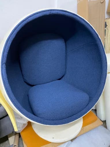 White ball chair with navy blue interior upholstery