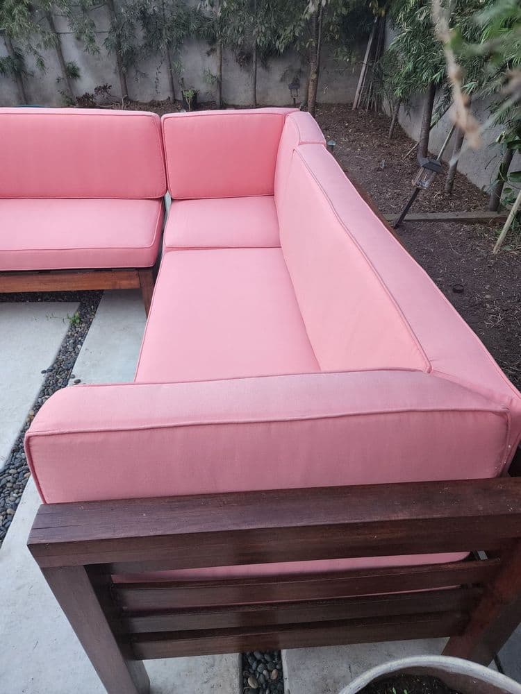 Close view of coral outdoor sectional cushions with piped edges