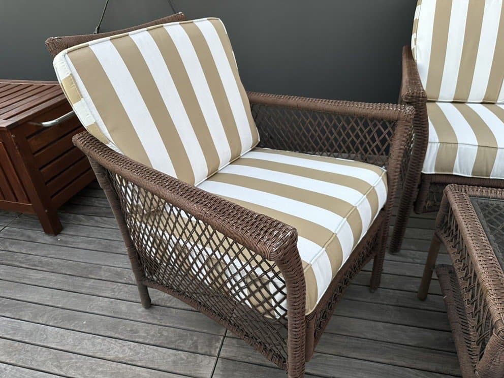 Wicker patio chairs with custom tan and white striped cushions
