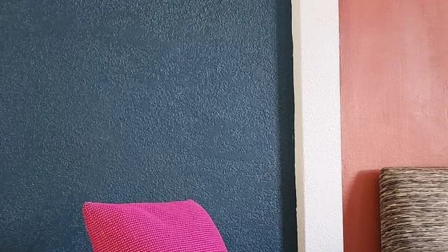 Textured teal and terracotta walls with custom upholstery accents